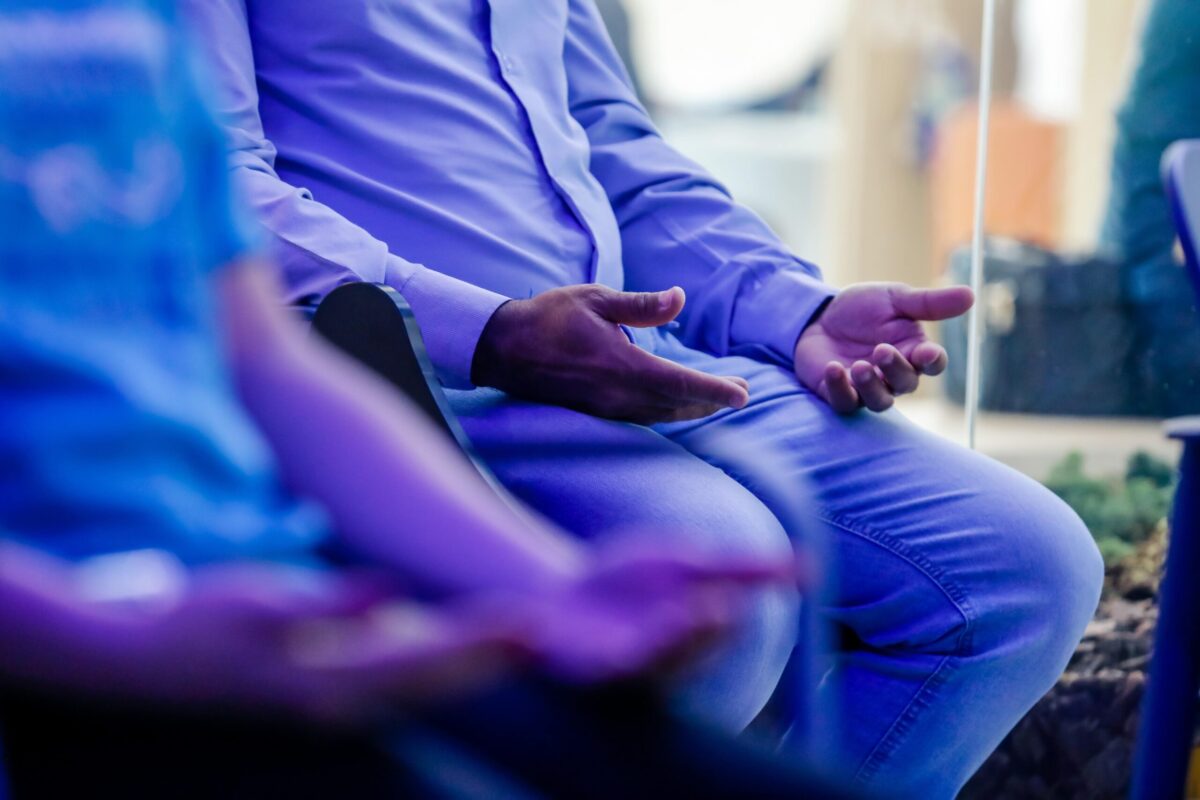 The image shows people participating in a self-care activity focused on their hands